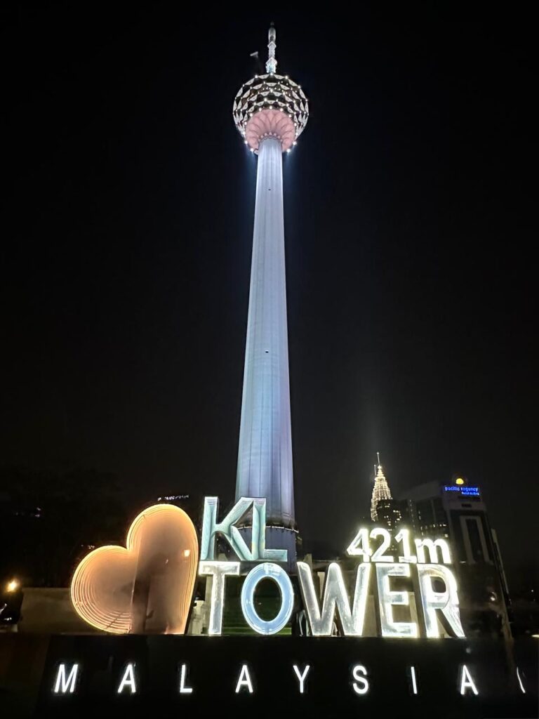 Visitor standing in the glass Sky Box at KL Tower