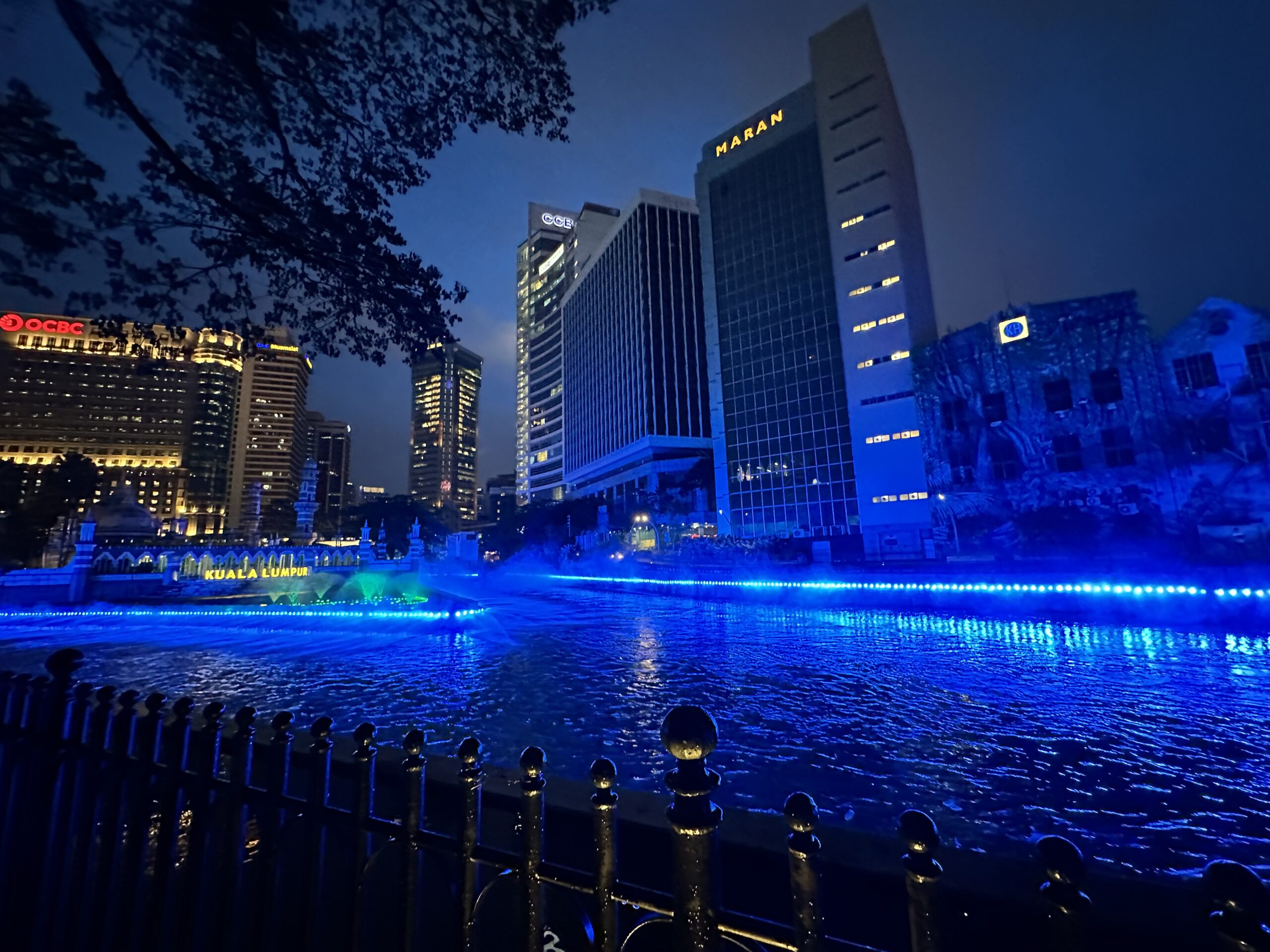 Night view of River of Life Kuala Lumpur with blue lights and mist