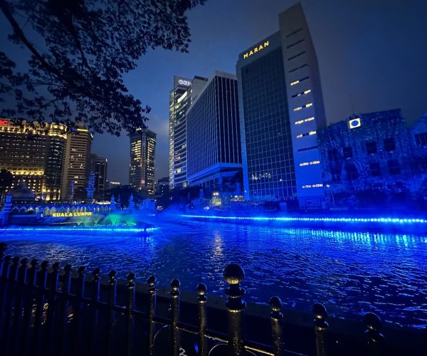 Night view of River of Life Kuala Lumpur with blue lights and mist