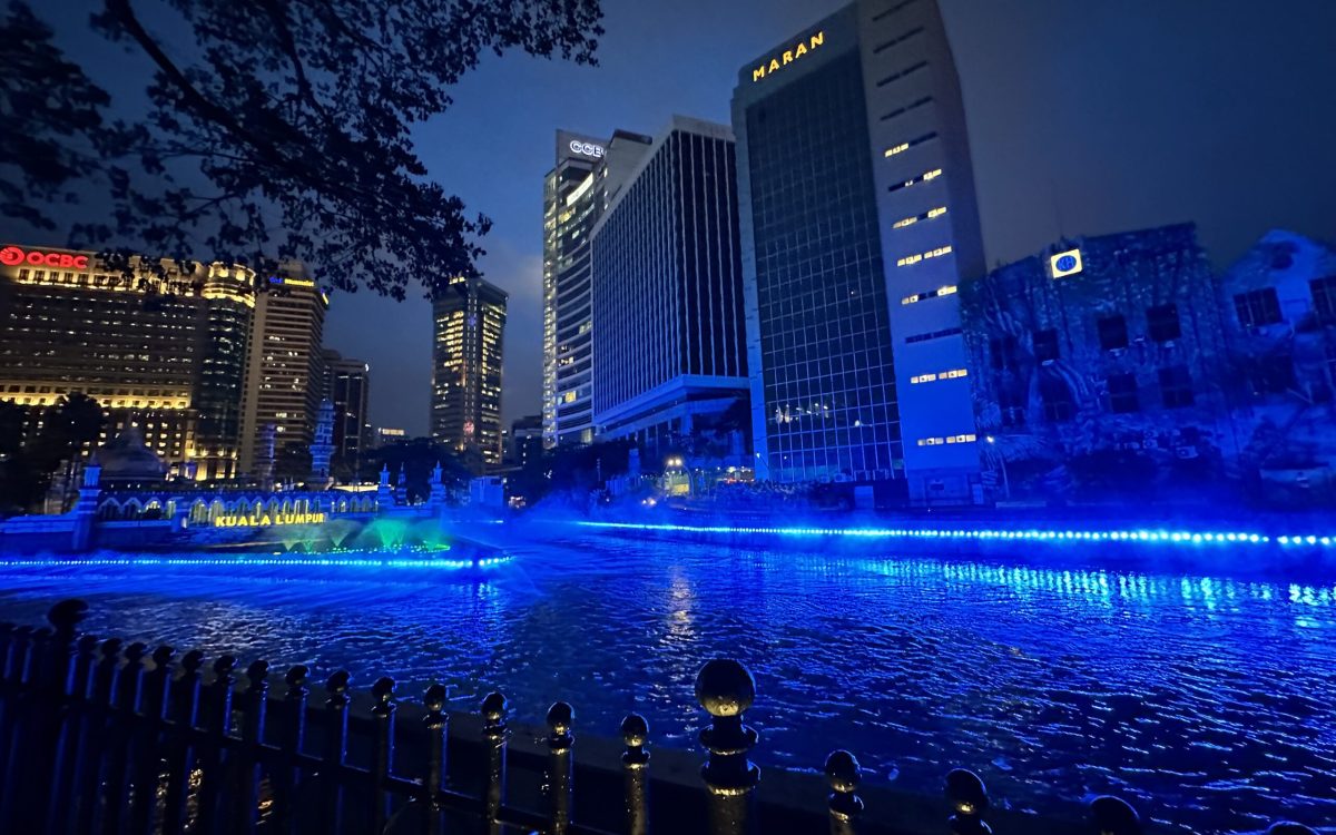 Night view of River of Life Kuala Lumpur with blue lights and mist